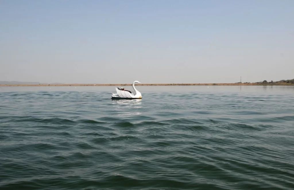 tourist enjoy with traditional wooden boat at Khindsi Lake, Boating is popular recreational activity among tourists in India.